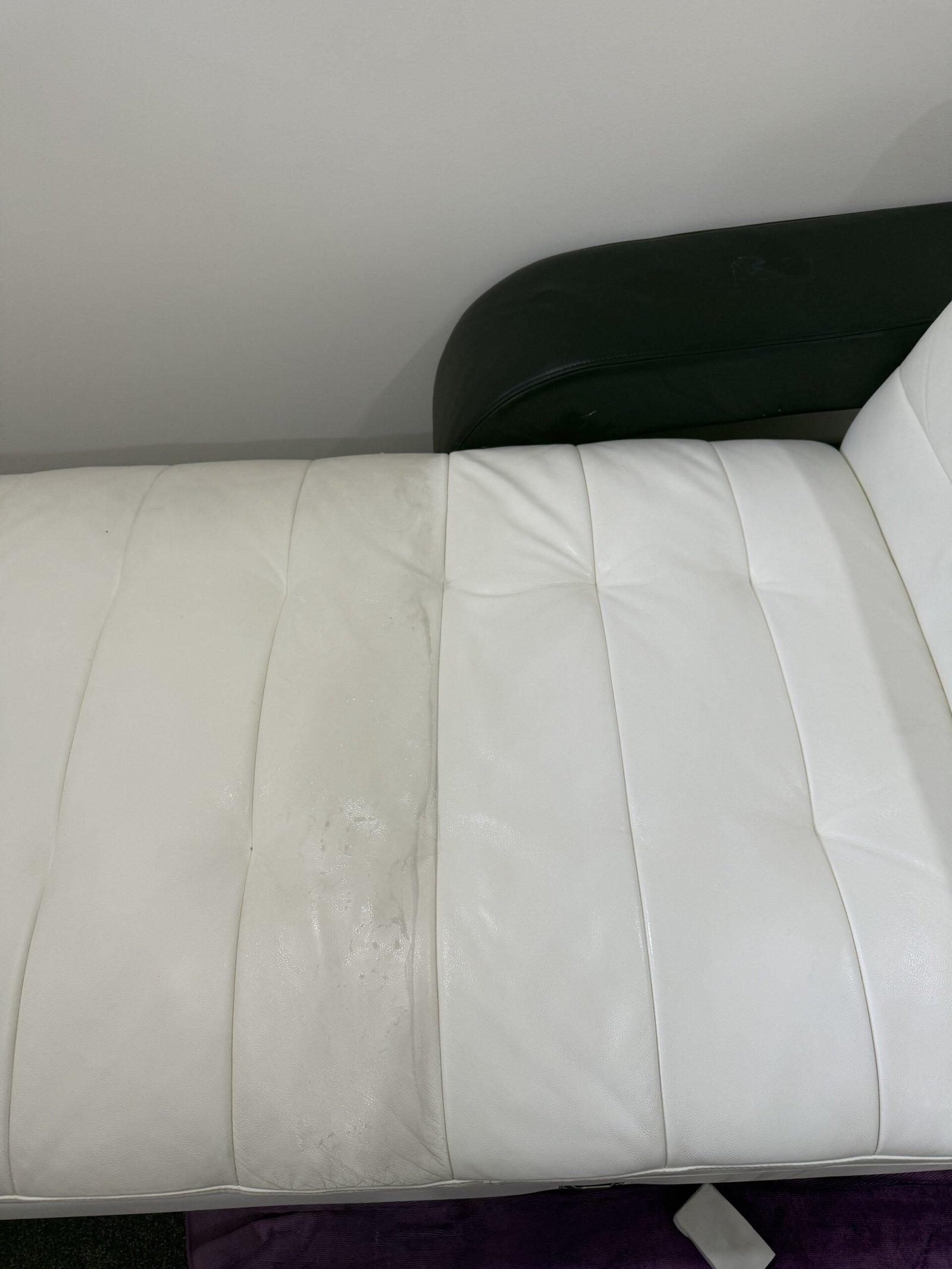 White leather chaise with stains before cleaning
